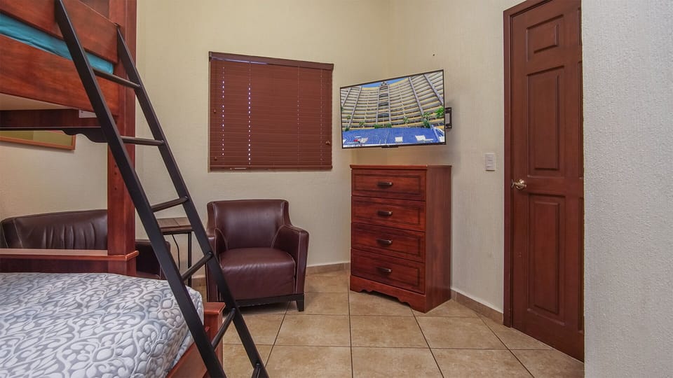 The TV and dresser in the fourth bedroom.