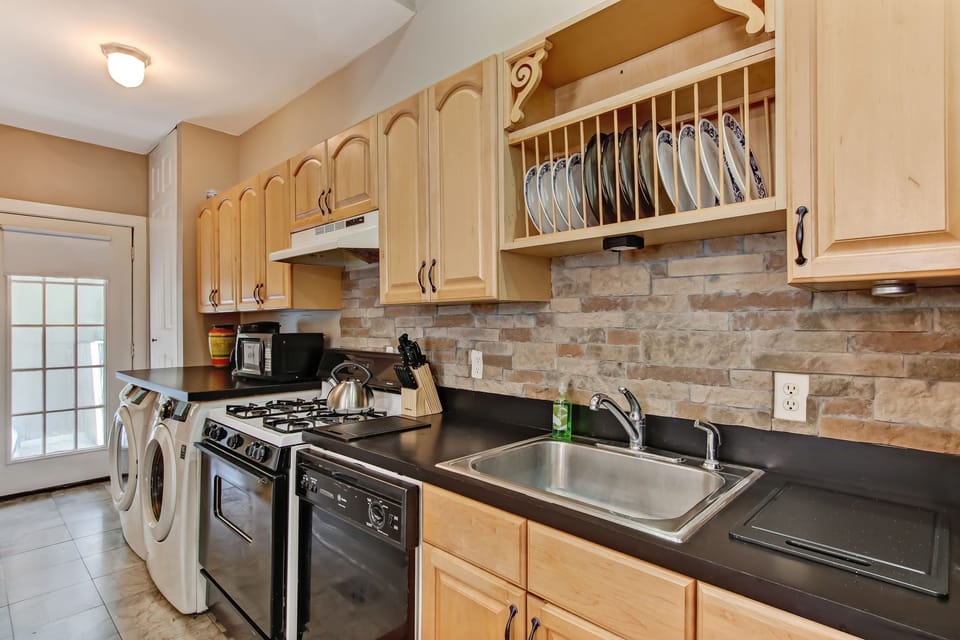 Galley kitchen runs toward back of house and opens to back deck. 