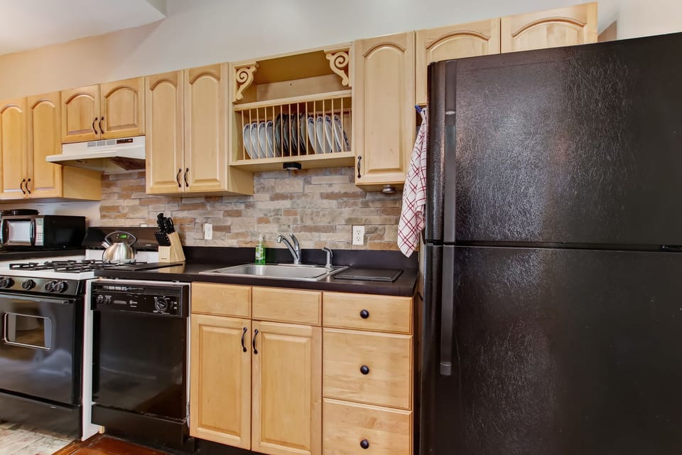 Appliances are full size. The stove is gas, for those culinary enthusiasts. 