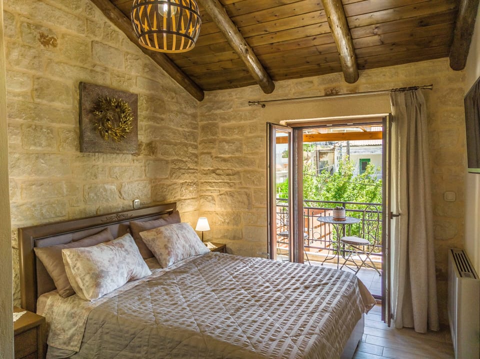 The first bedroom with queen size bed, a tv and a balcony at the first floor.