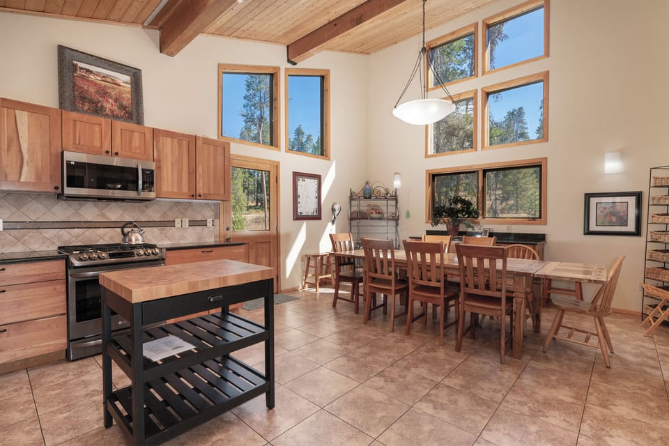 Kitchen and dining area located on the main level of the home. Dining table offers seating for 8.