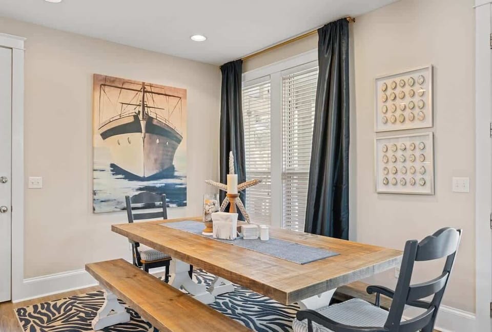 - Gather around this charming table beneath coastal art for memorable vacation meals - Nautical accents & natural light create a bright, beachy vibe for every bite - Bench and chair seating make this space ideal for casual breakfasts or group dinners