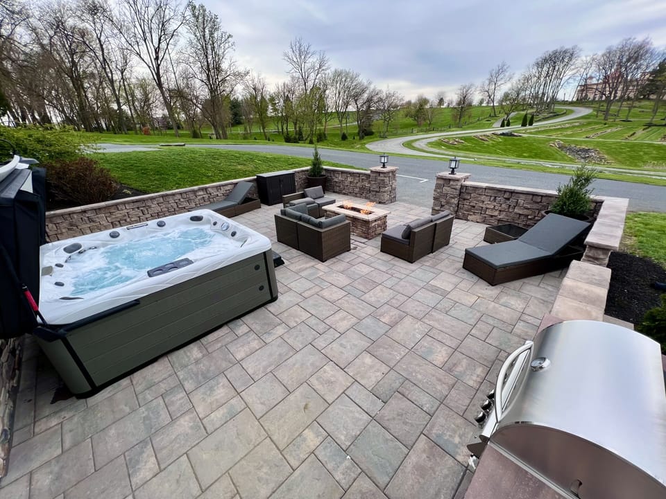 Outdoor Patio with large Hot Tub, Fire Pit, and view of Sight & Sound Theatre