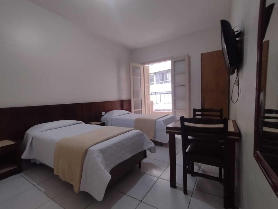 Family Room | Minibar, desk, WiFi (free), bed sheets