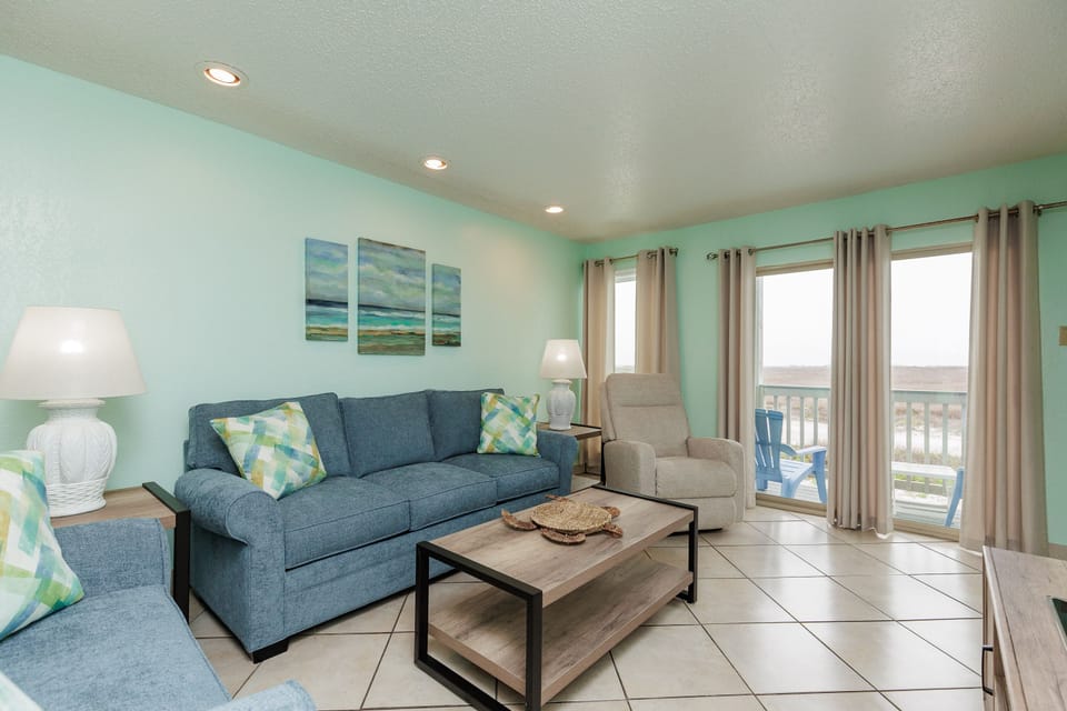 Sink into this coastal-inspired living room where soft blues and comfortable seating invite you to unwind after beach days.