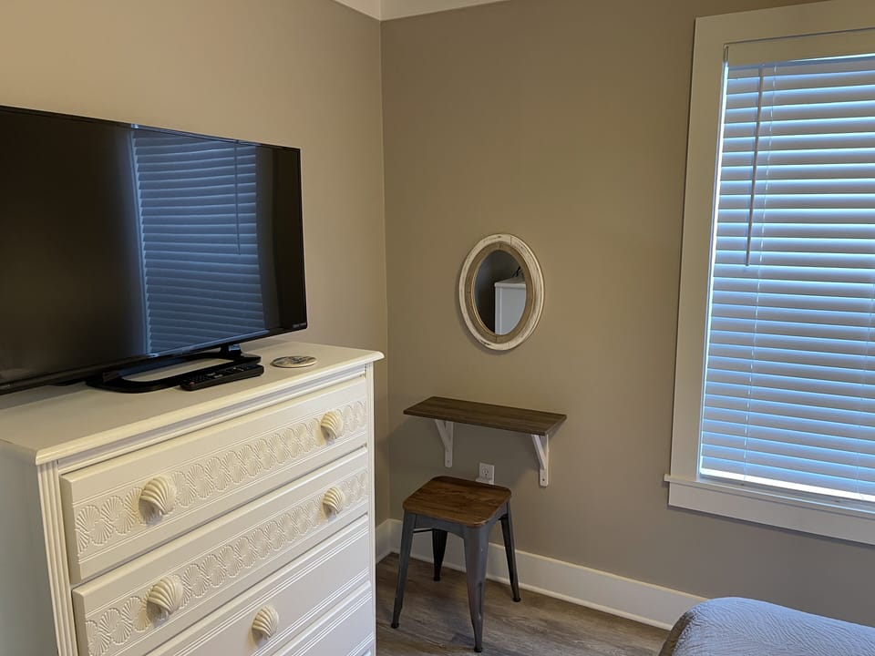 Flat Screen TV and Vanity Area in Queen Bedroom