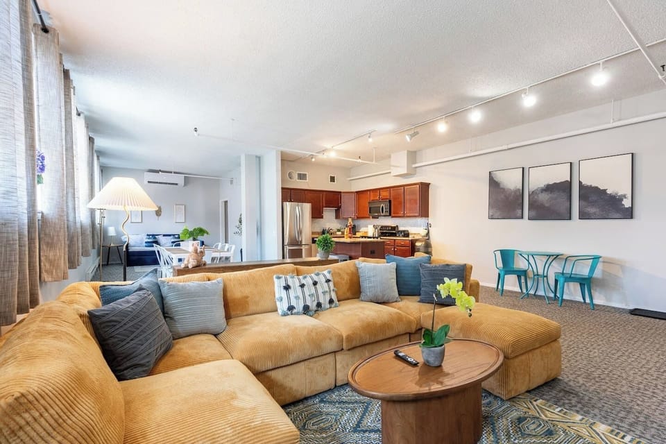 A spacious living room with comfortable seating and warm, homey touches that make it easy to relax after a day out.