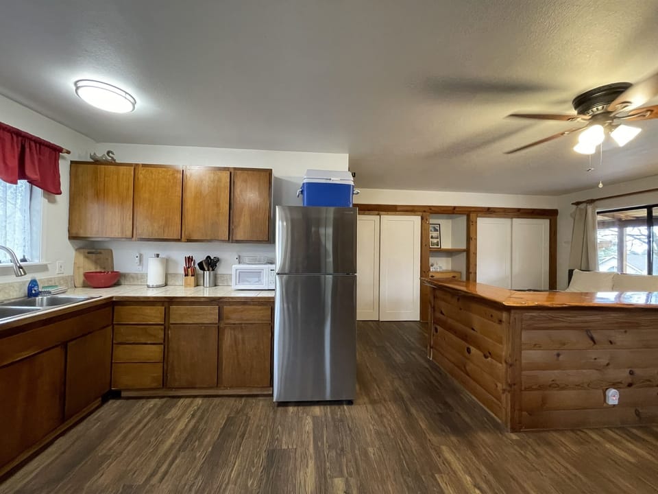 Kitchenette with fridge, microwave, sink, coffee maker & toaster.