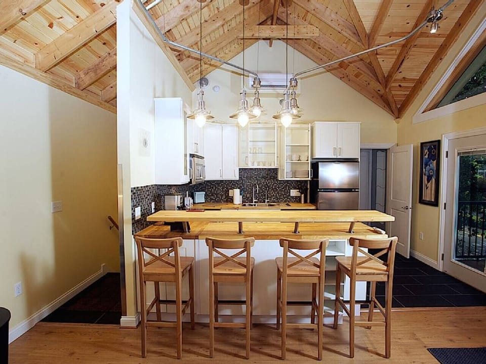 Dig into your family's meal or late-night snacks at the raised counter at the kitchen in Tradhuset (treehouse)