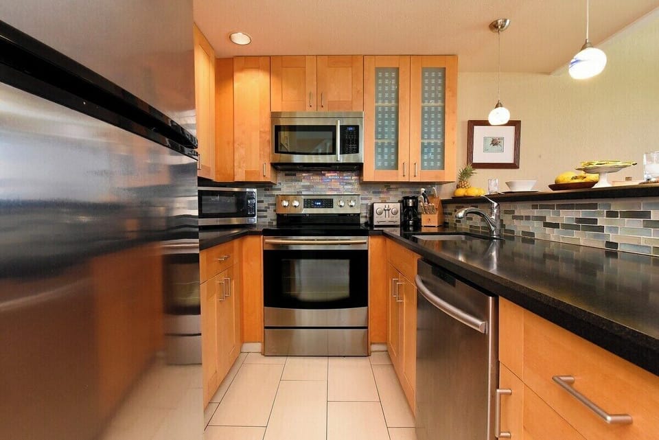 Modern, fully equipped kitchen with stainless steel appliances and all the essentials for home-cooked meals.