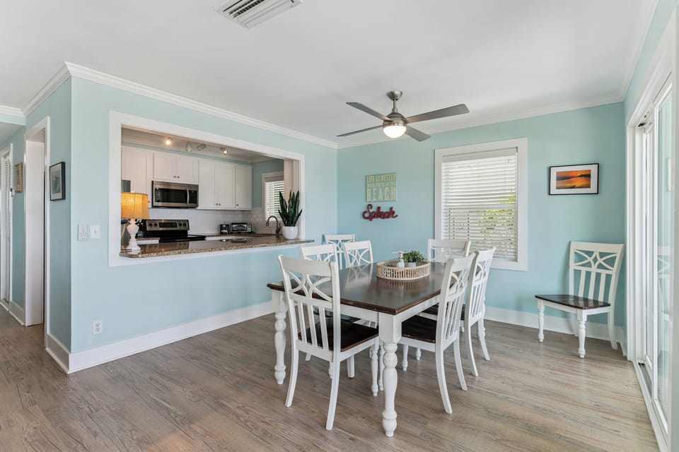 Gather around the dining table in this breezy coastal space, where calming blue walls and charming white furnishings invite your group to linger over meals and memories together.