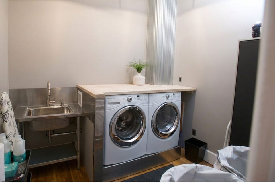 Large laundry features full-size washer and dryer next to laundry sink - this laundry room is shared with Vetehuset - Plantera