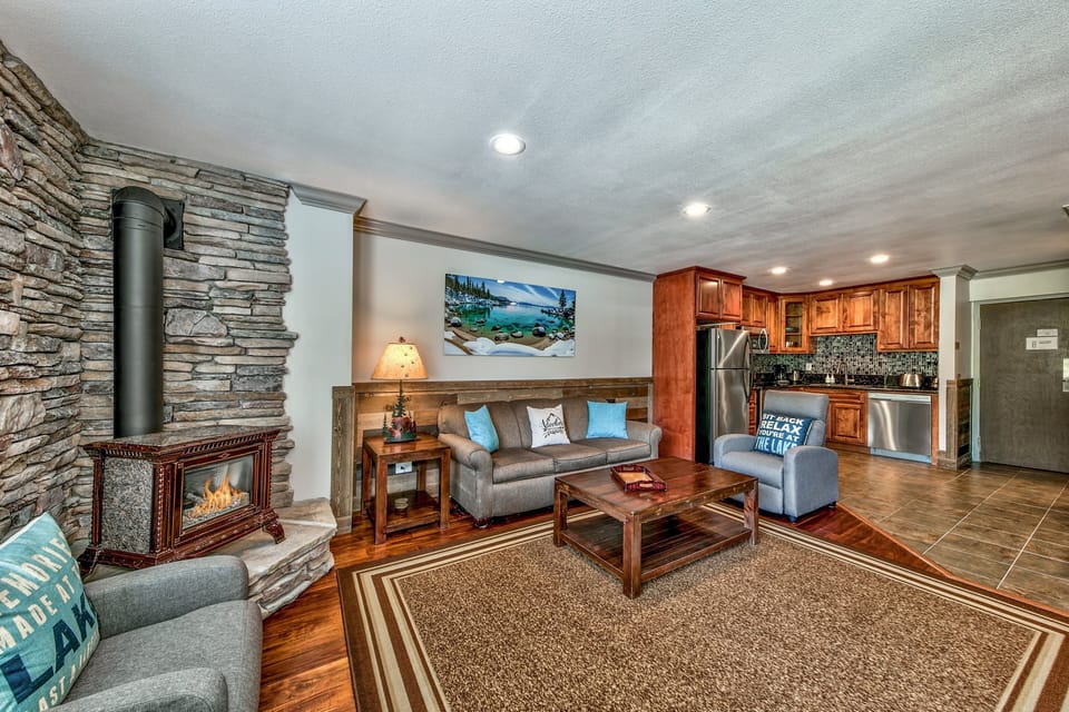 Unwind in your cozy living space where rustic charm meets modern comfort—crackling fireplace, plush seating, and a fully equipped kitchen await your arrival.