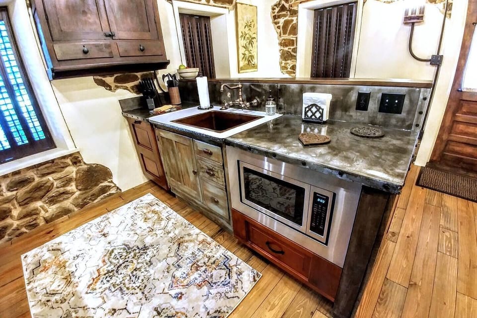 Main level kitchen in the historic Stenhuset's upper level features distressed zinc countertops
