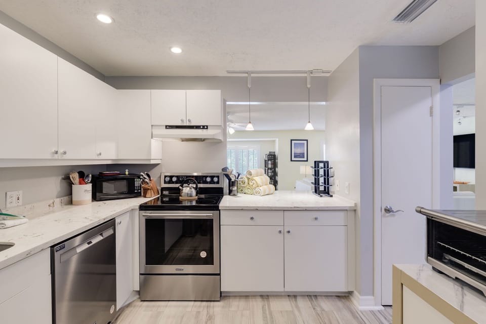 renovated kitchen with stainless appliances and quartz countertops (with glow in the dark sea animals built in)