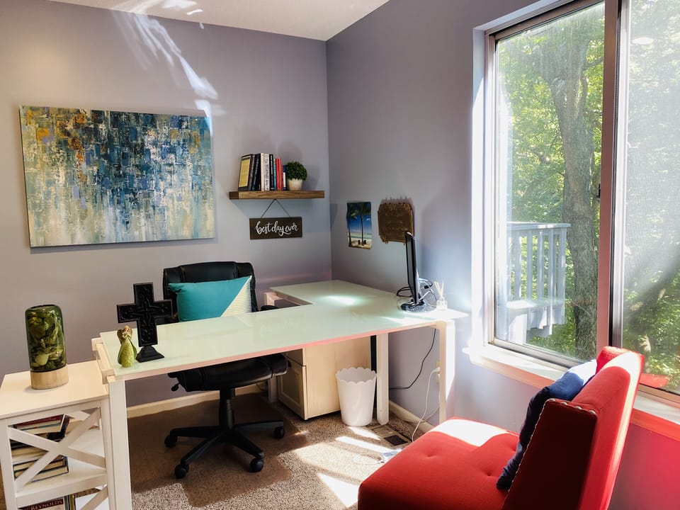 L-shaped desk with beautiful views of the private backyard