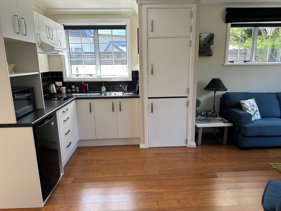 Kitchen area with microwave and hob.