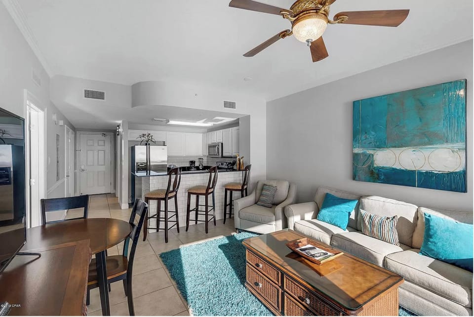 Relax in your bright, coastal-inspired living space with comfortable seating and an open kitchen perfect for preparing meals together.