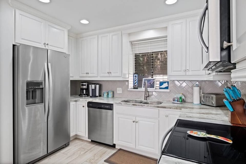 Our renovated kitchen with stainless steel appliances, fully stocked cabinets