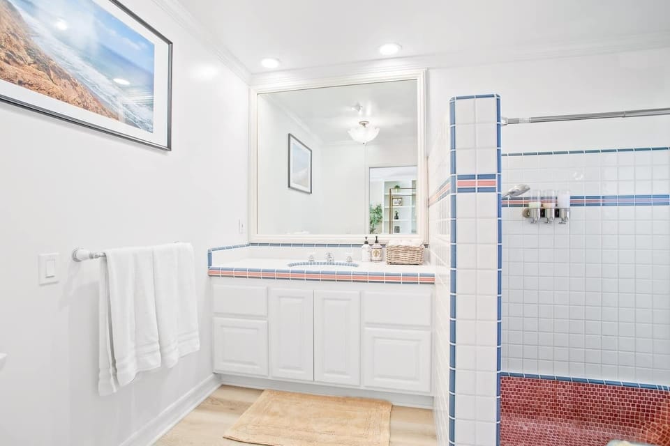 Spacious master bathroom with connected private patio for coastal breeze, and completely unique roman style tub - a midcentury modern touch. Take a look at the other photo as well for a complete visual.