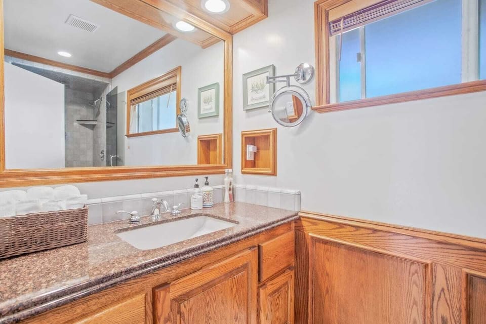Spacious full bathroom with dual shower heads, soft and luxurious towels and travel supplies such as bath soap, shampoo, conditioner, lotion and more.