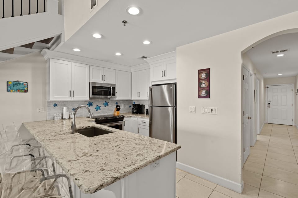 Your bright, modern kitchen features granite countertops, stainless steel appliances, and an open layout perfect for preparing meals and gathering with loved ones.