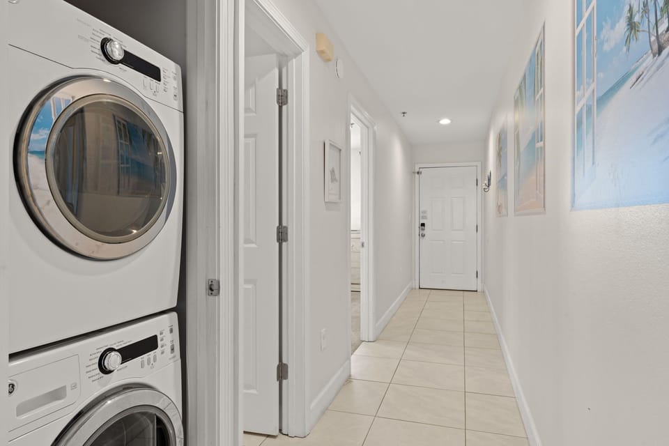 1st Floor - Your laundry is handled with stacked washer and dryer tucked neatly into the hallway, keeping your vacation effortless and your clothes fresh for beach days.