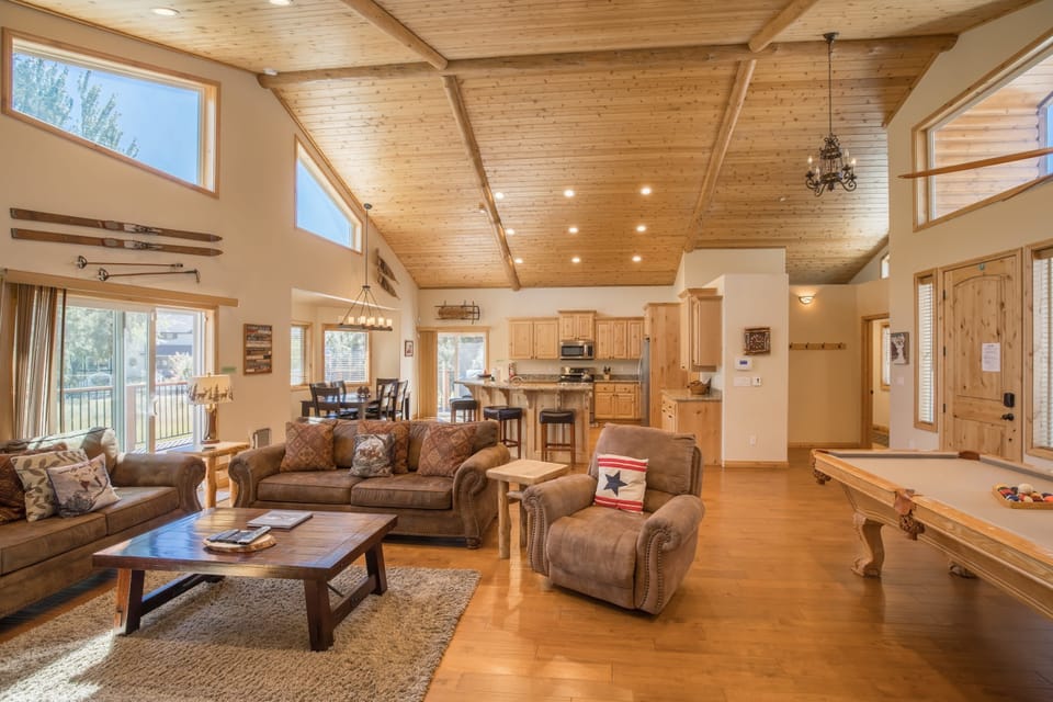 Open concept living area with towering wood beam ceilings.