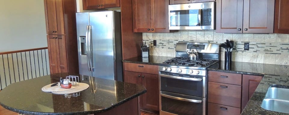 Cooks kitchen with stainless appliances and lots of work space