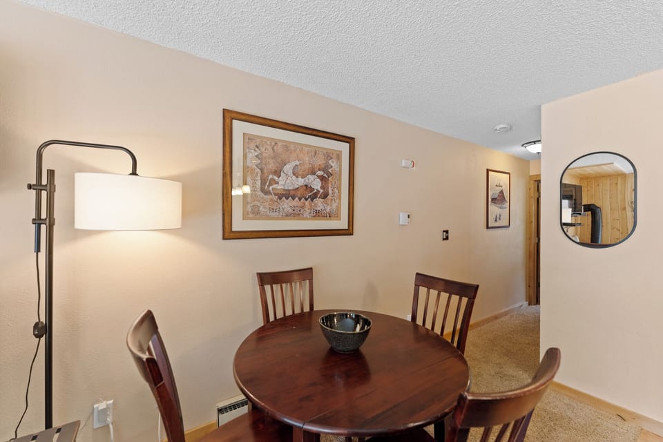 Gather around your cozy dining table for memorable meals with loved ones in this warm, thoughtfully decorated space.
