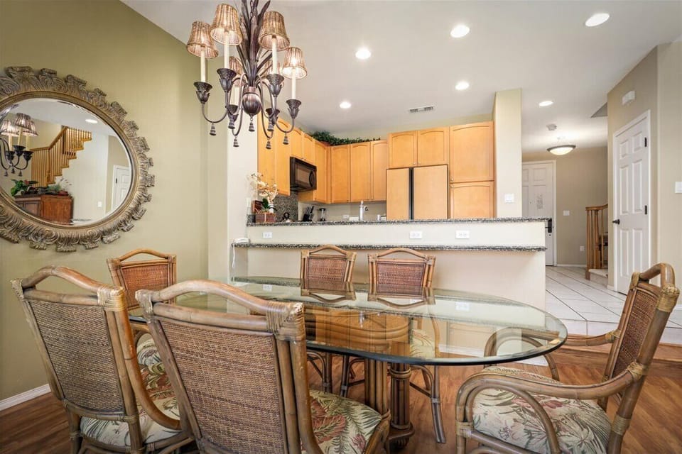 Gather with loved ones around this spacious dining table, where your vacation memories are made over shared meals. Just steps away, a well-equipped kitchen makes meal prep effortless, while elegant lighting sets the mood.
