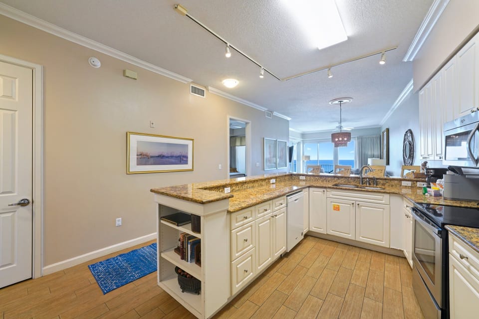 Airy open layout kitchen with island and ocean-view seating area