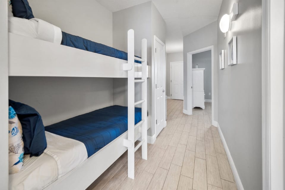Your kids will love this bright bunk room with crisp blue bedding and modern touches.