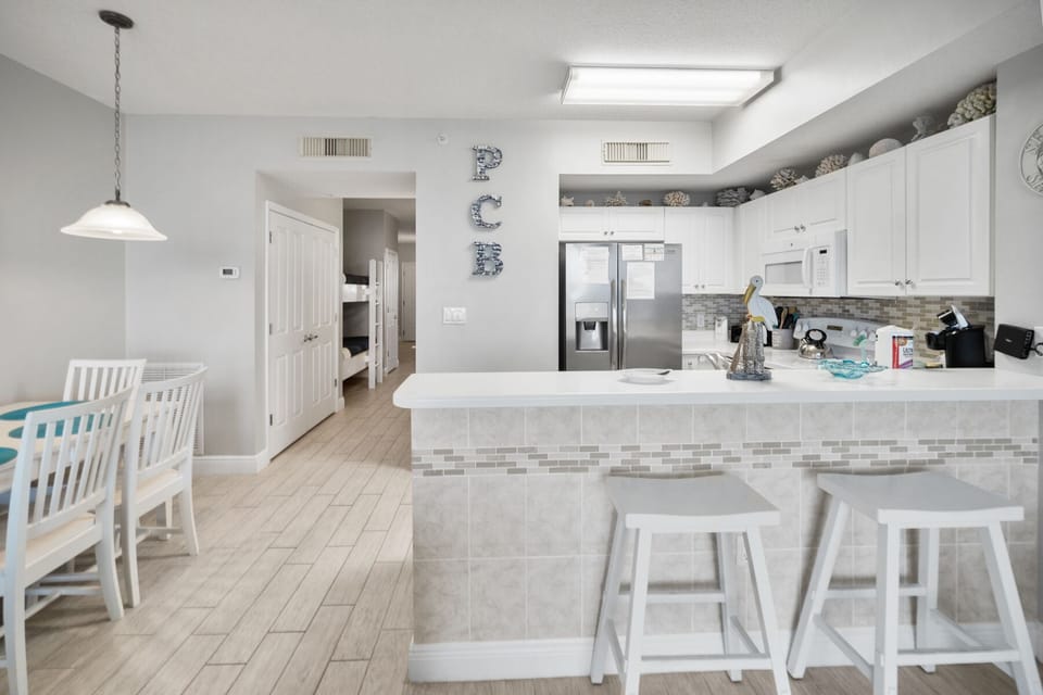 Your bright, open kitchen invites culinary creativity with gleaming countertops, modern appliances, and a breakfast bar perfect for morning coffee.