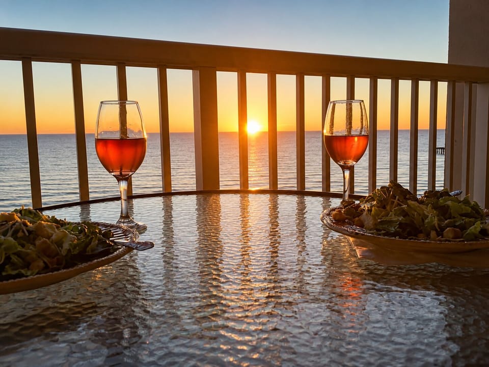 Sip your evening wine on your private balcony as golden sunset light dances across the ocean horizon.