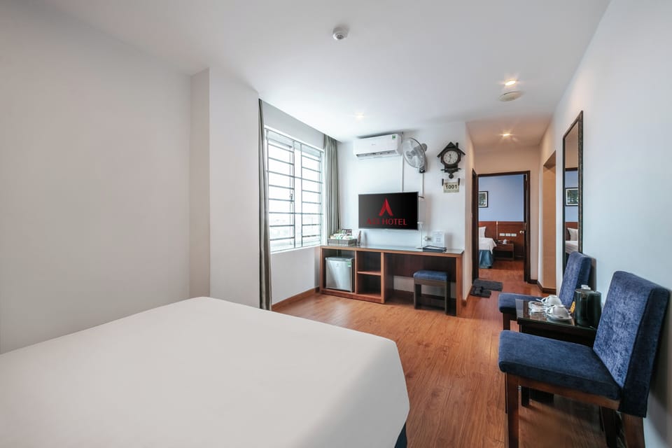 Family Suite Room | Minibar, in-room safe, blackout drapes, iron/ironing board