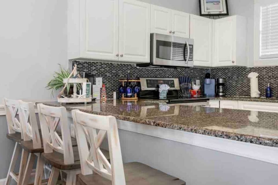 Sit at the bar top while sharing snacks and cooking as a family.
