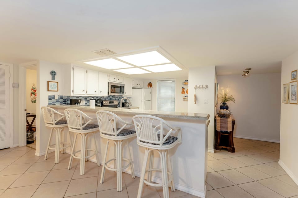 Our kitchen is just off the entry way and includes a lovely little breakfast bar with seating for 4.