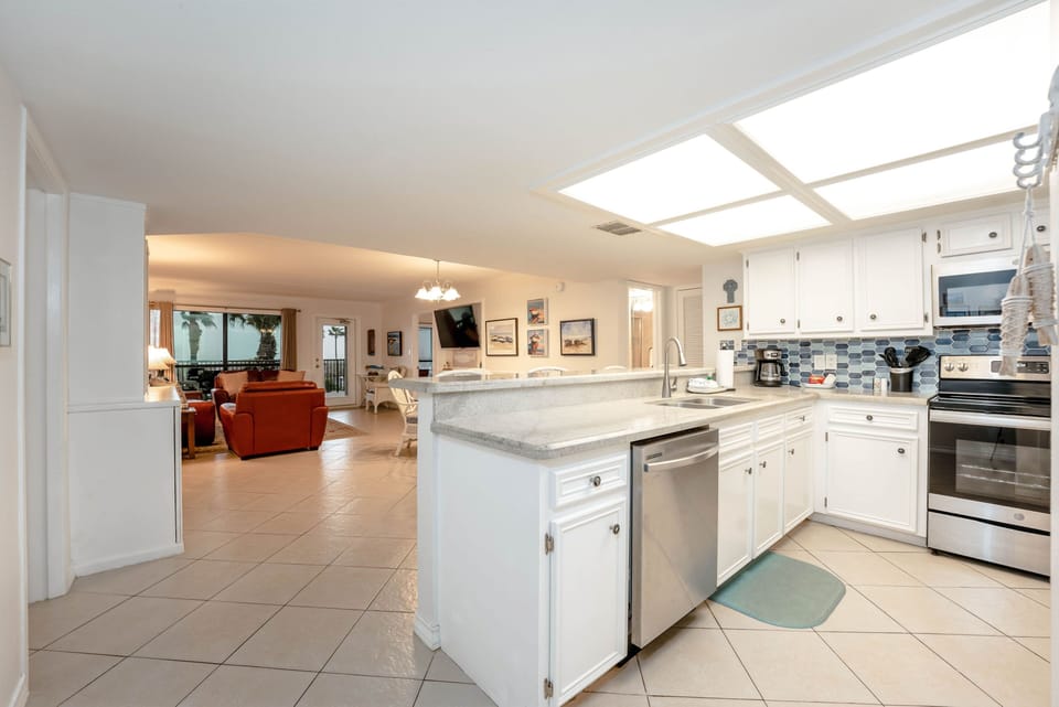 Our entire living space, all the way through the kitchen, is filled with light from our huge balcony windows that overlook the resort.