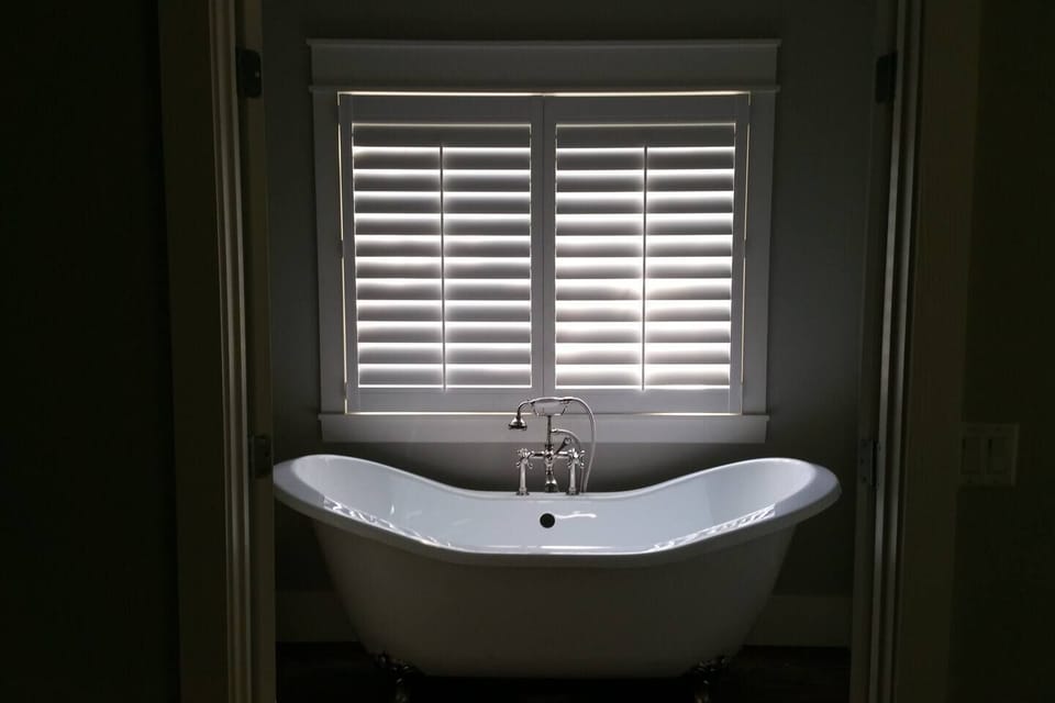 Clawfoot tub and shower in upstairs bathroom of cottage rental