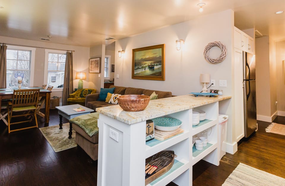 Enjoy open concept kitchen/living/dining space w/ 2 stools at kitchen counter 