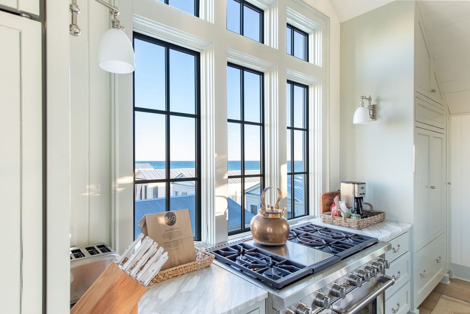 Chef's Kitchen with Natural Lighting, Luxury Marble Island, and Vaulted Shiplap Ceilings