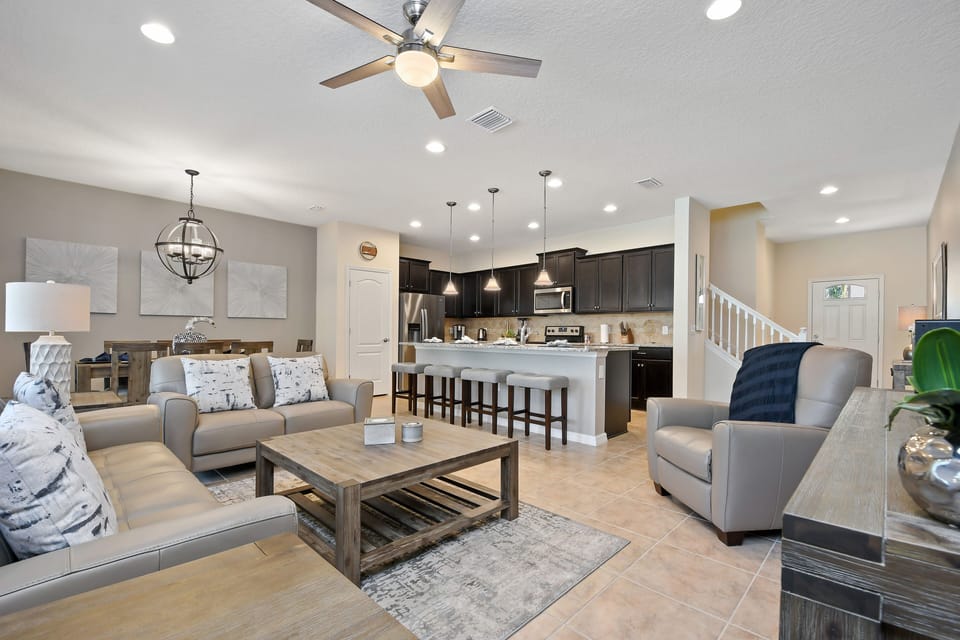 Stunning living room area with modern style kitchen and barstool seating