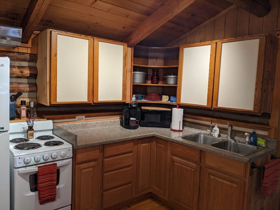 Kitchen. Microwave, Keurig coffee maker, pots and pans for cooking. 
