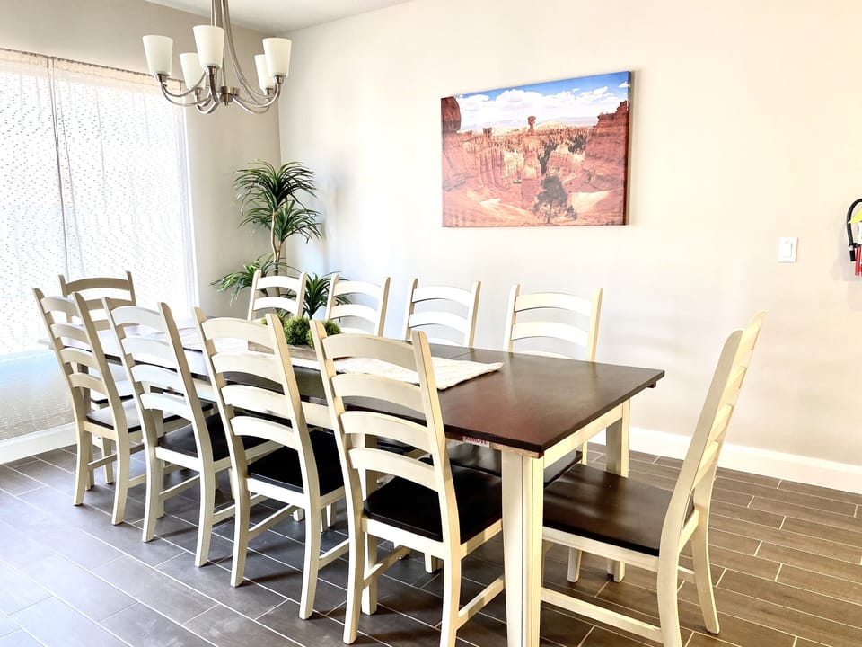 Table with 10 chairs and an extra leaf that can be added for additional space