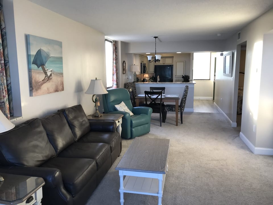 Living area with leather couch and recliners