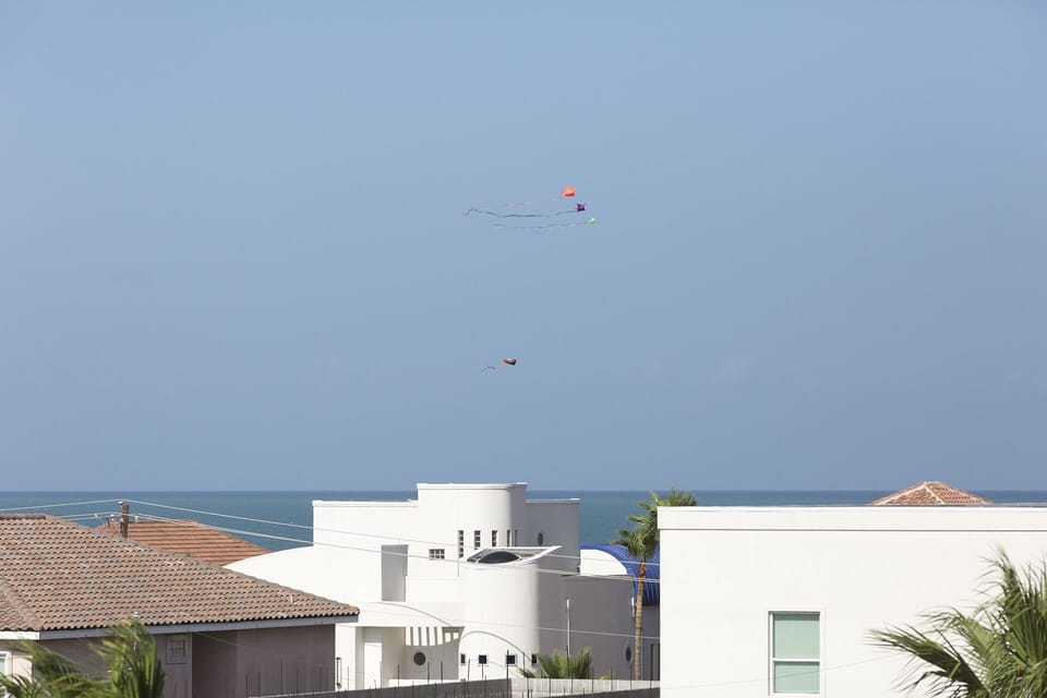 Rooftop deck with coastal breezes and views stretching toward the Gulf