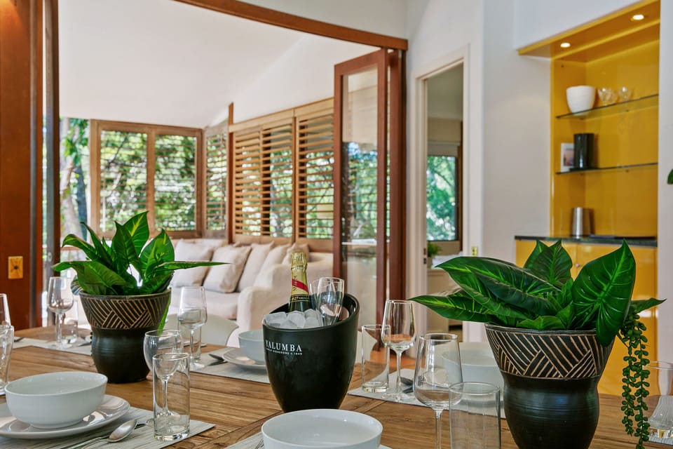 Dining beside the kitchen seats 12, with alfresco space for Noosa outdoor meals.