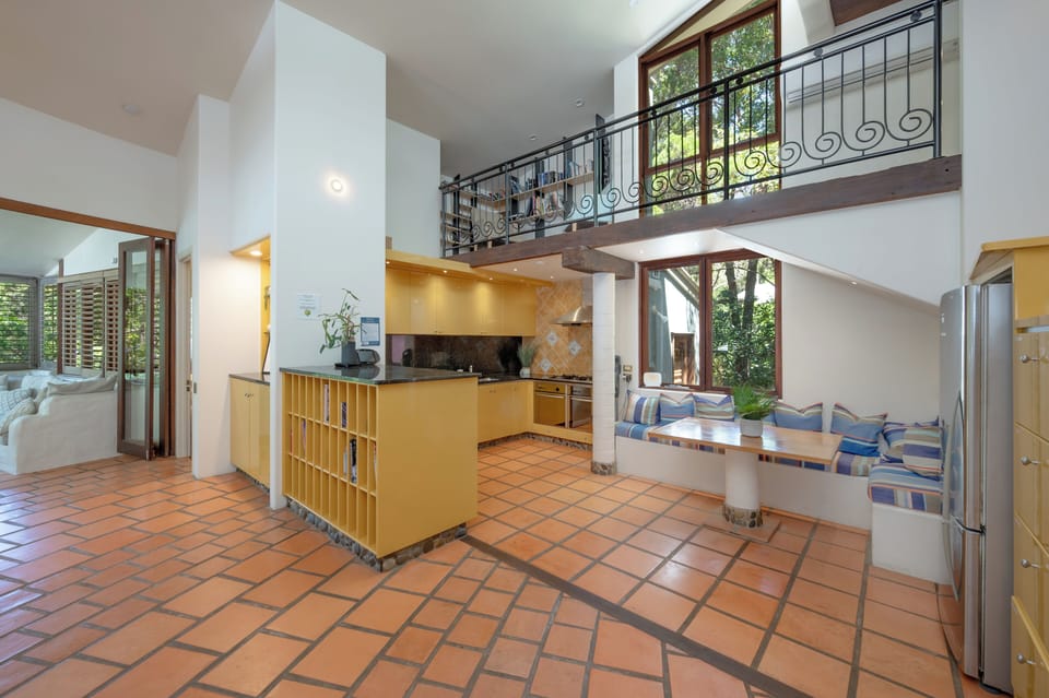 Gourmet kitchen with dual ovens, breakfast seating and Nespresso coffee machine.