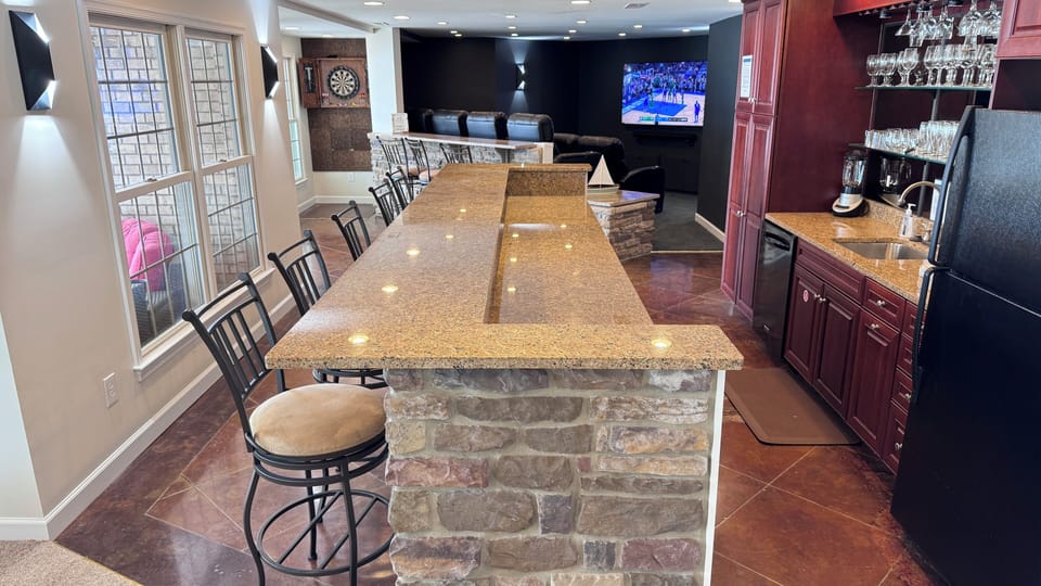 Entertainment level wet bar with full size refrigerator, microwave, & dishwasher